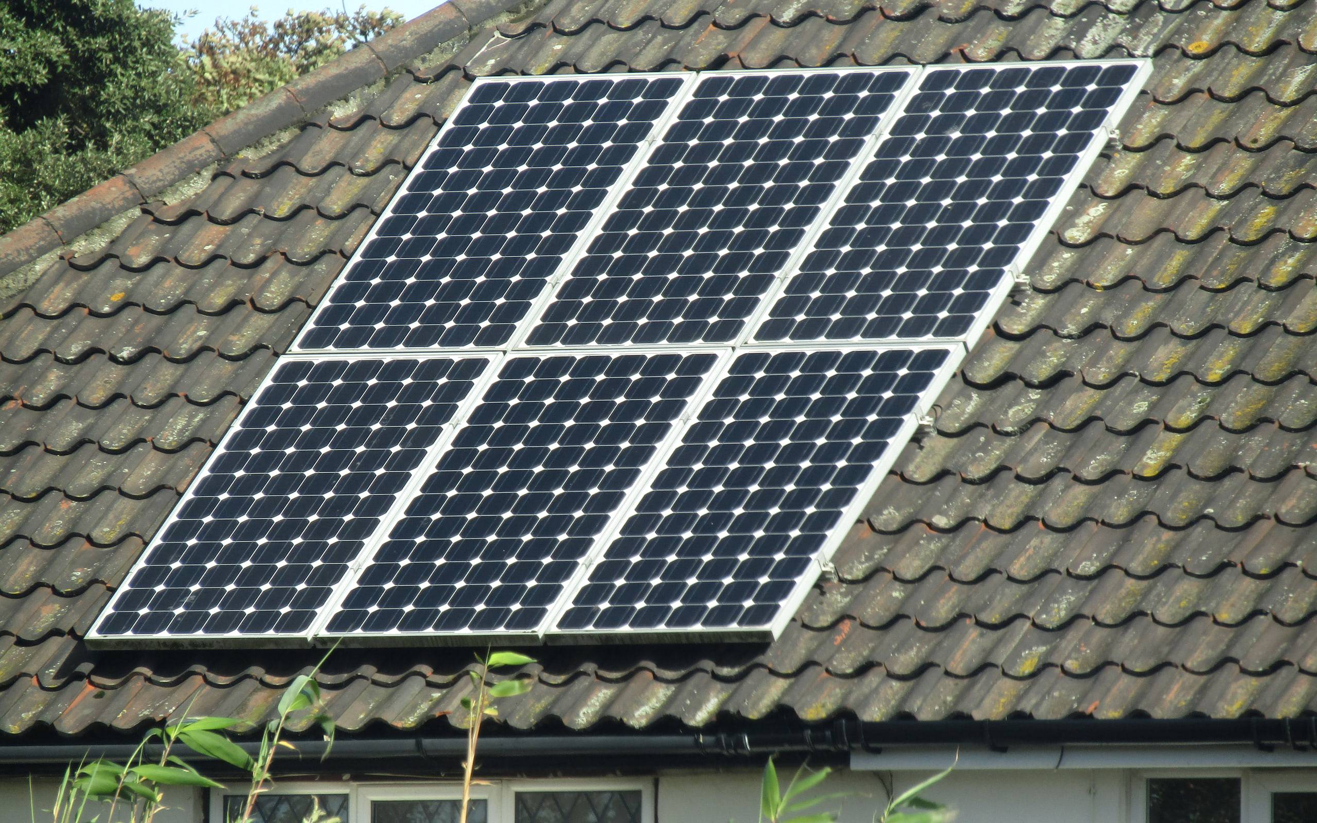 Solar panels fitted across a pitched house roof