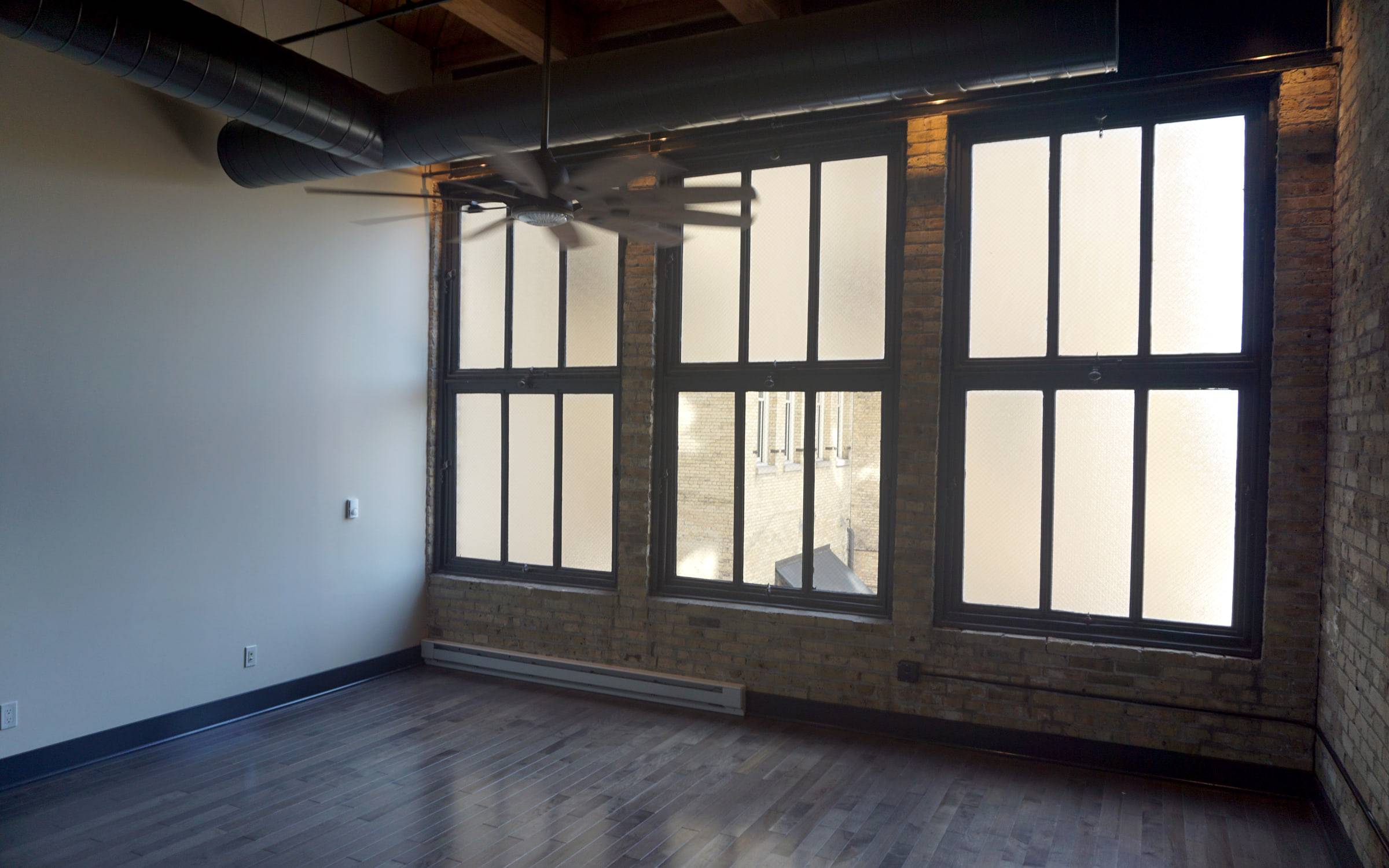 Living room with tall windows and a polished floor