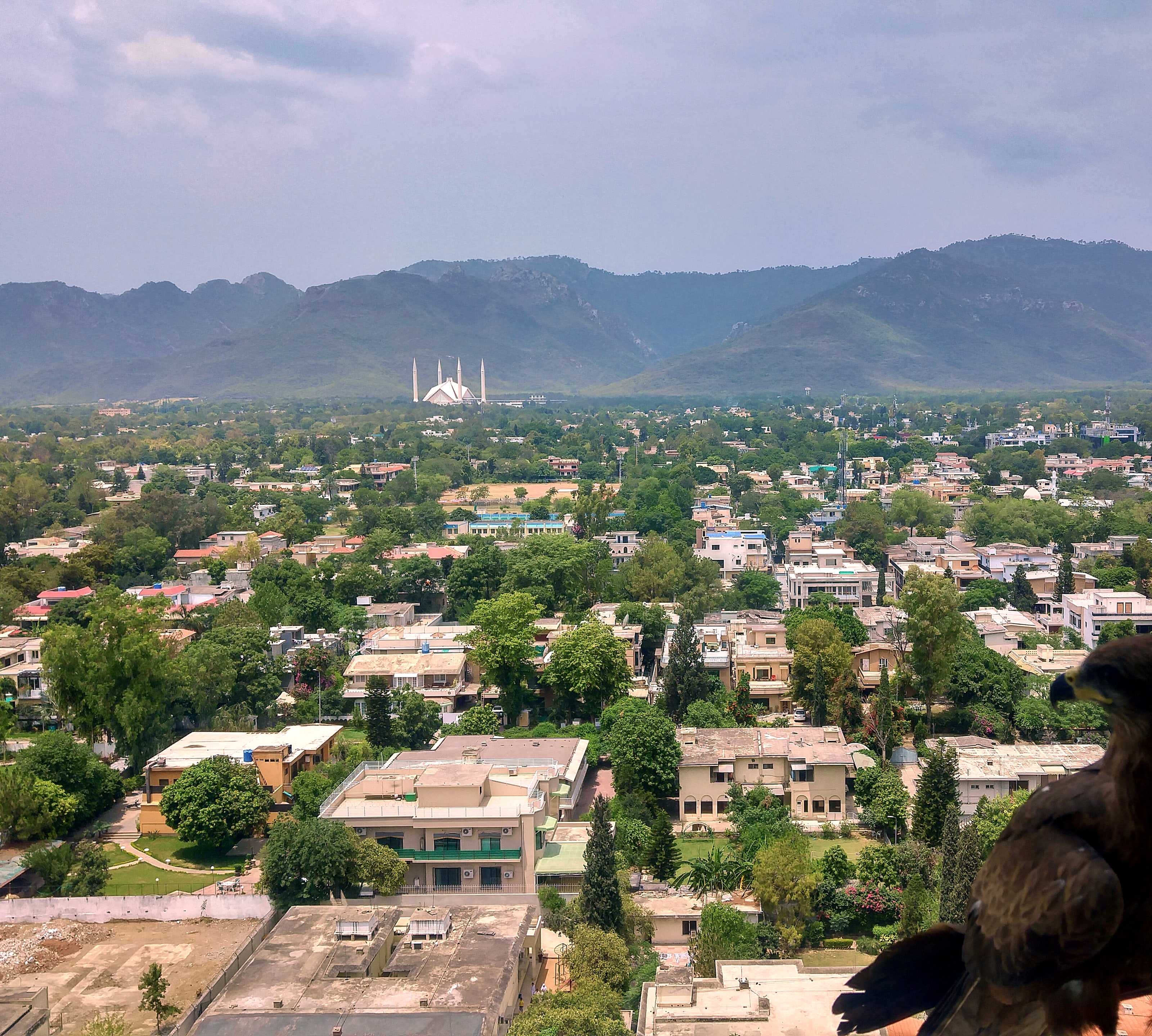 Islamabad seen from above, with Faisal Mosque and the Margalla Hills in the distance