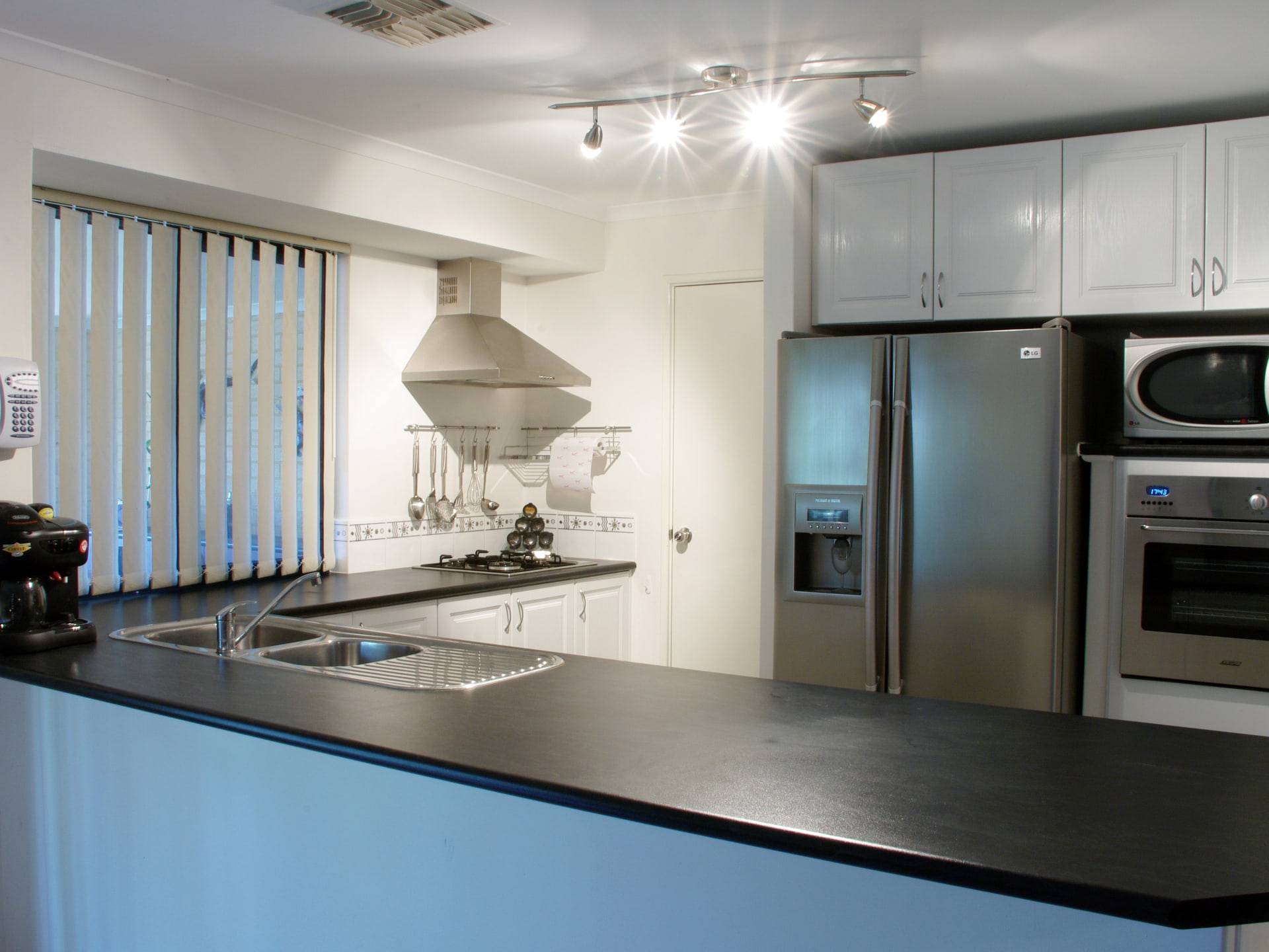 A modern kitchen with a long island and integrated appliances