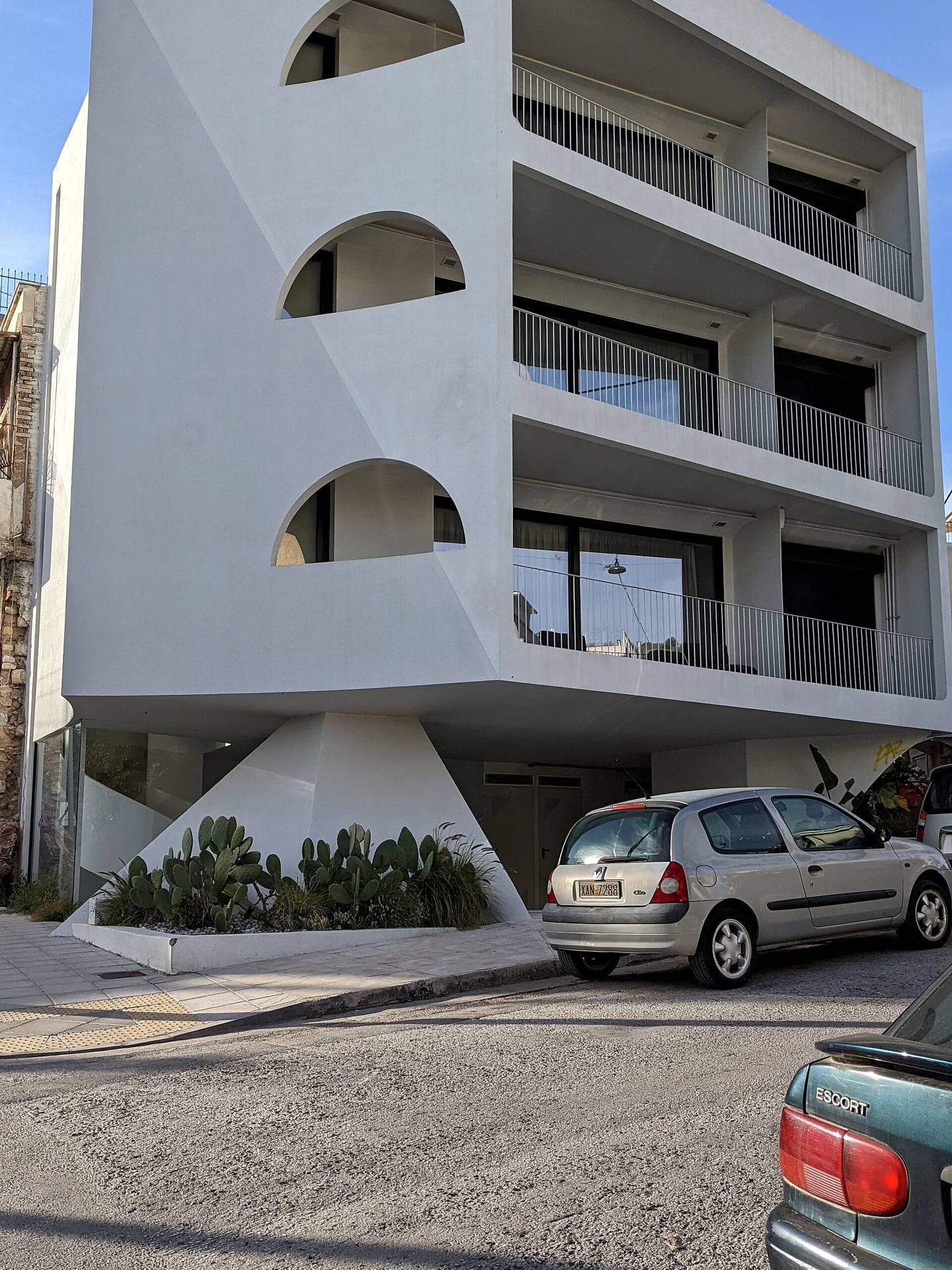 A low-rise modern apartment building with balconies
