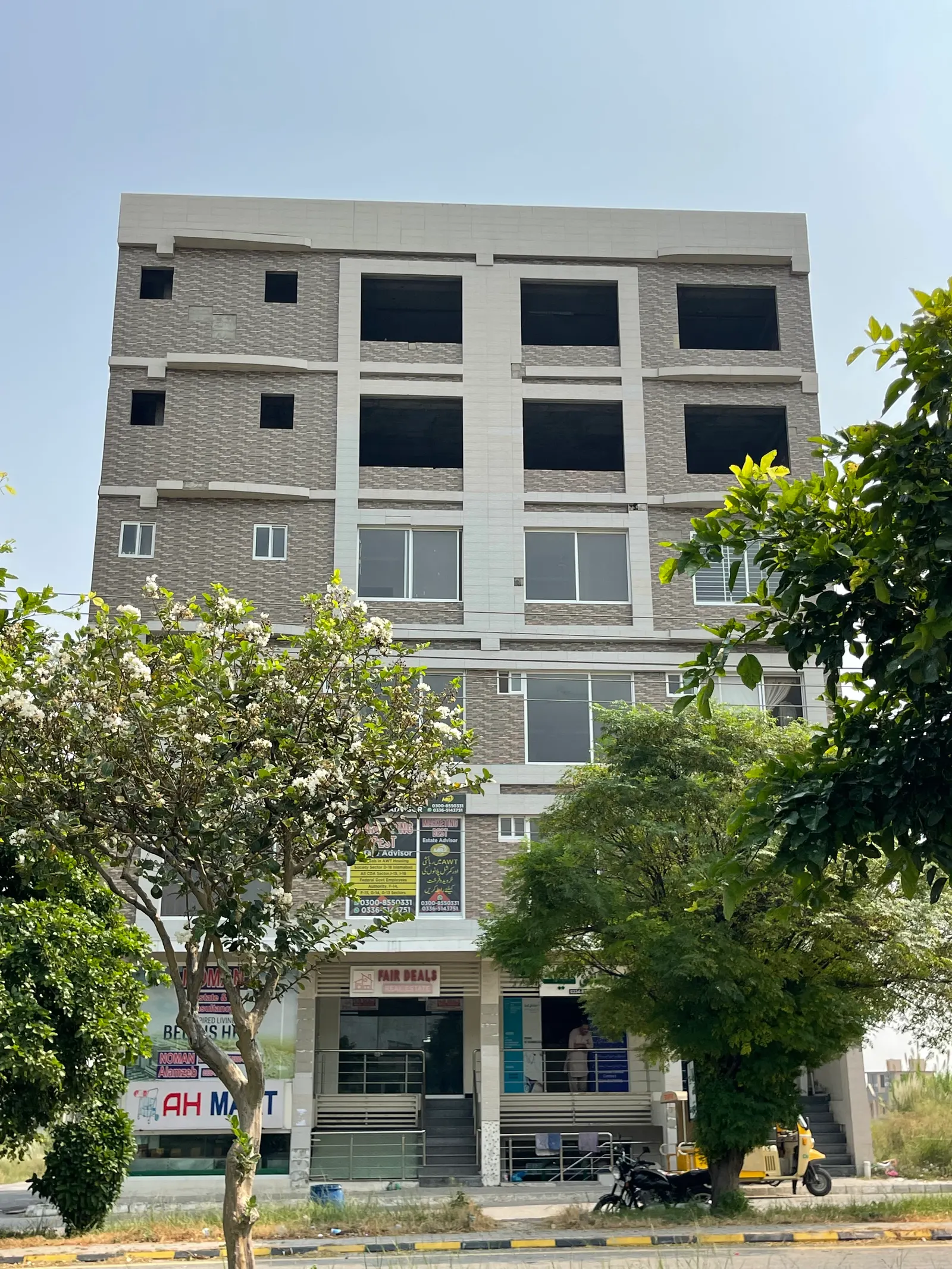 AH Arcade commercial building, front view with ground-floor shops open