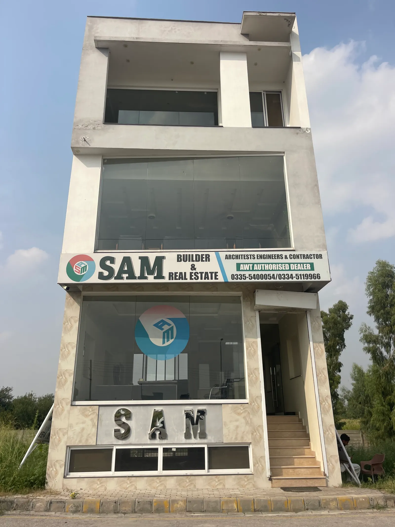 SAM Builder & Real Estate office building with signage